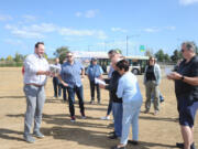 Ridgefield City Manager Steve Stuart discusses new businesses coming to Union Ridge Town Center near Interstate 5 with city council, planning commission and parks board members during a development tour Monday afternoon.