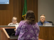 Evergreen school board members Victoria Bradford, left, and Superintendent John Boyd, right, listen to public comment Tuesday evening during a board meeting at Evergreen headquarters. Like other meetings in recent months, Tuesday's session featured testimonies from parents frustrated with unaddressed safety concerns and staffing shortages.