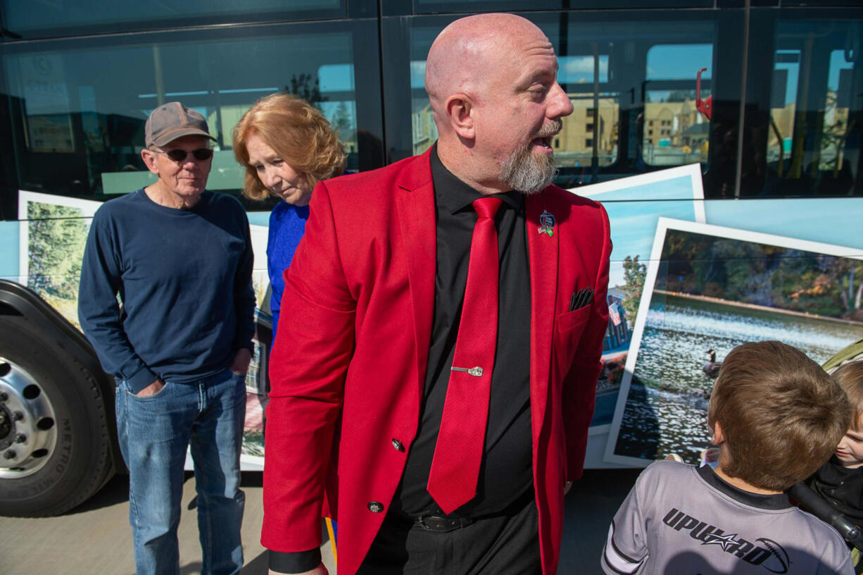 Shawn Donaghy, C-Tran CEO, sports a red blazer at the ribbon cutting ceremony Saturday for the transit agency's new Vine bus rapid transit service.