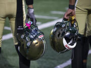 Evergreen players hold their helmets on the sideline before a game against Mountain View at McKenzie Stadium on Friday, Sept. 29, 2023.