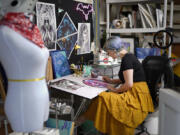 Artist Kelly McKernan paints in their studio Tuesday, Aug. 15, 2023, in Nashville, Tenn. McKernan is an artist and one of three plaintiffs in a lawsuit against artificial intelligence companies they allege have infringed on their copyright.