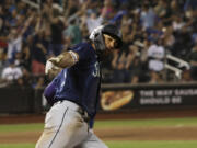 Seattle Mariners' JP Crawford celebrates as he rounds the bases after hitting a home run during the ninth inning of a baseball game against the New York Mets, Saturday, Sept. 2, 2023, in New York.