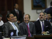 Texas Attorney General Ken Paxton, center, sits between defense attorneys Tony Buzbee, left, and Mitch Little, right, before his impeachment trial resumes in the Senate Chamber at the Texas Capitol on Friday, Sept. 15, 2023, in Austin, Texas.