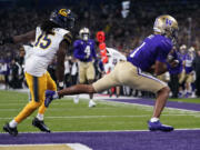 Washington wide receiver Rome Odunze (1) scores a touchdown next to California defensive back Lu-Magia Hearns III (15) during the first half of an NCAA college football game Saturday, Sept. 23, 2023, in Seattle.