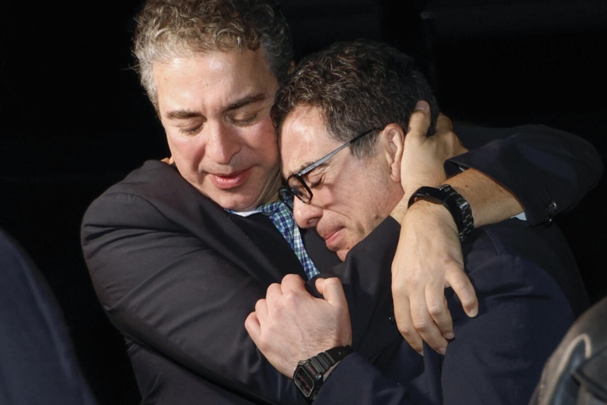A family member embraces freed American Siamak Namazi after he and four fellow detainees were released in a prisoner swap deal between U.S and Iran, arrived at Davison Army Airfield, Tuesday, Sept. 19, 2023 at Fort Belvoir, Va.