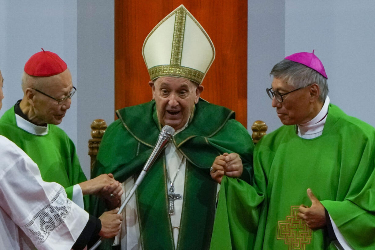 Pope Francis is joined by Cardinal John Tong Hon, left, and Cardinal-elect Stephen Chow, both from Hong Kong, after presiding over a mass at the Steppe Arena in the Mongolian capital Ulaanbaatar, Sunday, Sept. 3, 2023. Francis is in Mongolia to minister to one of the world's smallest and newest Catholic communities. Neighboring China's crackdown on religious minorities has been a constant backdrop to the trip, even as the Vatican hopes to focus attention instead on Mongolia and its 1,450 Catholics.