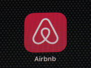 FILE - The Airbnb app icon is displayed on an iPad screen in Washington, D.C., on May 8, 2021. Airbnb says it's cracking down on fake listings, which are emerging as a major problem for customers of the short-term rental site. Airbnb said Wednesday Sept. 20 2023 it has removed 59,000 fake listings and blocked another 157,000 from joining the site this year. Fake listings and high cleaning fees are among several issues that customers are raising with Airbnb.