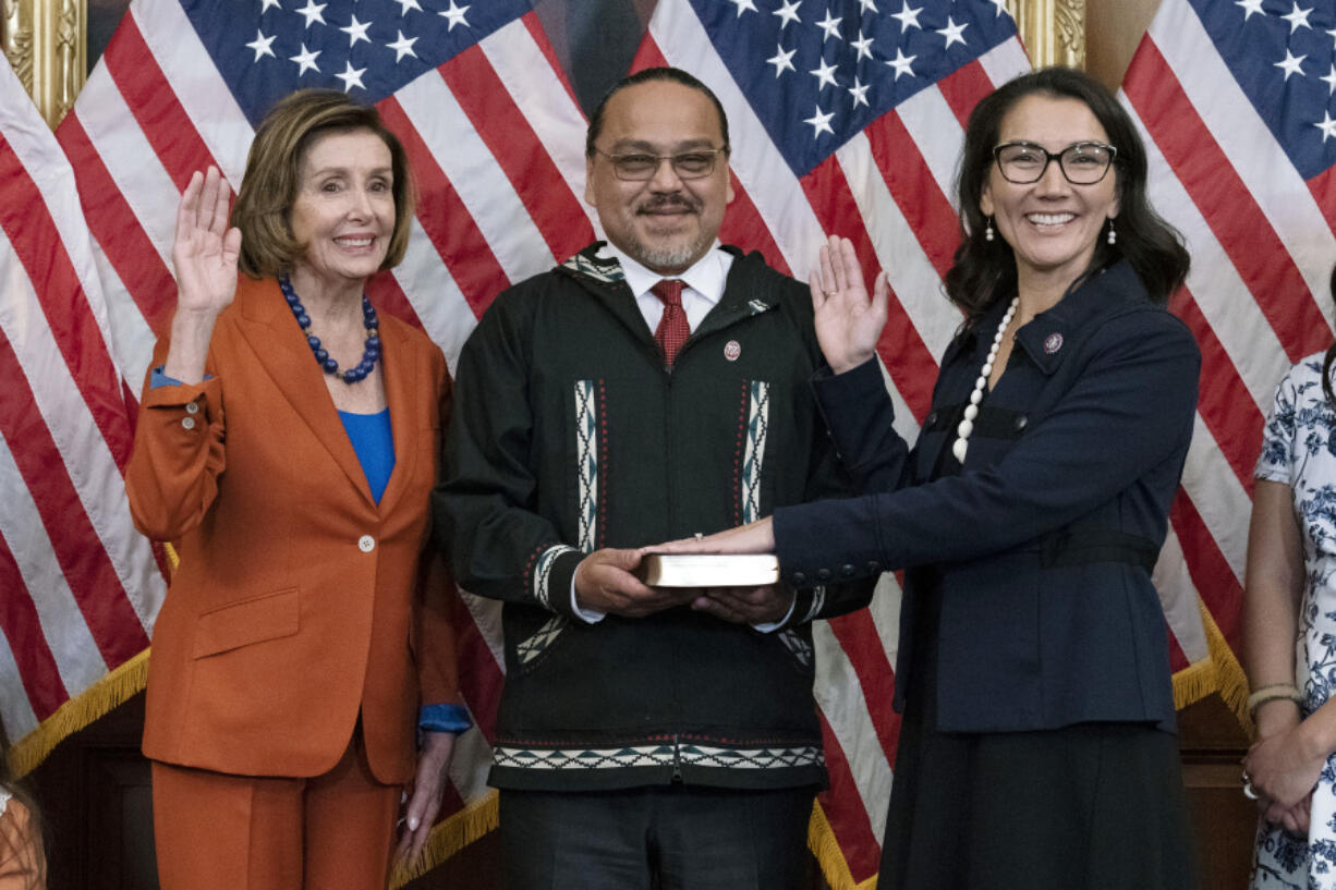 FILE - Speaker of the House Nancy Pelosi of Calif., left, administers the House oath of office to Rep. Mary Peltola, D-Alaska, standing next to her husband Eugene "Buzzy" Peltola Jr., center, during a ceremonial swearing-in on Capitol Hill in Washington, Tuesday, Sept. 13, 2022. Peltola's husband Eugene has died in an airplane crash in Alaska, her office said Wednesday, Sept. 13, 2023.