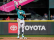 Seattle Mariners' Julio Rodriguez celebrates hitting an RBI double to score Josh Rojas against the Los Angeles Angels during the third inning of a baseball game Wednesday, Sept. 13, 2023, in Seattle.