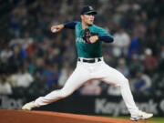 Seattle Mariners starting pitcher Bryan Woo throws against the Los Angeles Angels during the first inning of a baseball game, Tuesday, Sept. 12, 2023, in Seattle.