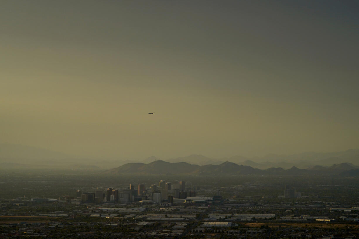 Clouds surround downtown Phoenix at sunset, Sunday, July 30, 2023. The city so far this year has seen 52 days of highs at 110 degrees or over and is expected to hit that mark again on both Saturday, Sept. 9, and Sunday.