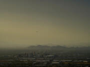 Clouds surround downtown Phoenix at sunset, Sunday, July 30, 2023. The city so far this year has seen 52 days of highs at 110 degrees or over and is expected to hit that mark again on both Saturday, Sept. 9, and Sunday.