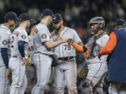 Houston Astros starting pitcher Justin Verlander gets a fist bump from catcher Marten Maldonado, second from right, before getting pulled by manager Dusty Baker, far right, in a meeting at the mound with shortstop Jeremy Pena, far left, third baseman Alex Bregman, second from left, and first baseman Jose Abreu (79) in the ninth inning of a baseball game against the Seattle Mariners, Monday, Sept. 25, 2023, in Seattle. The Astros won 5-1.