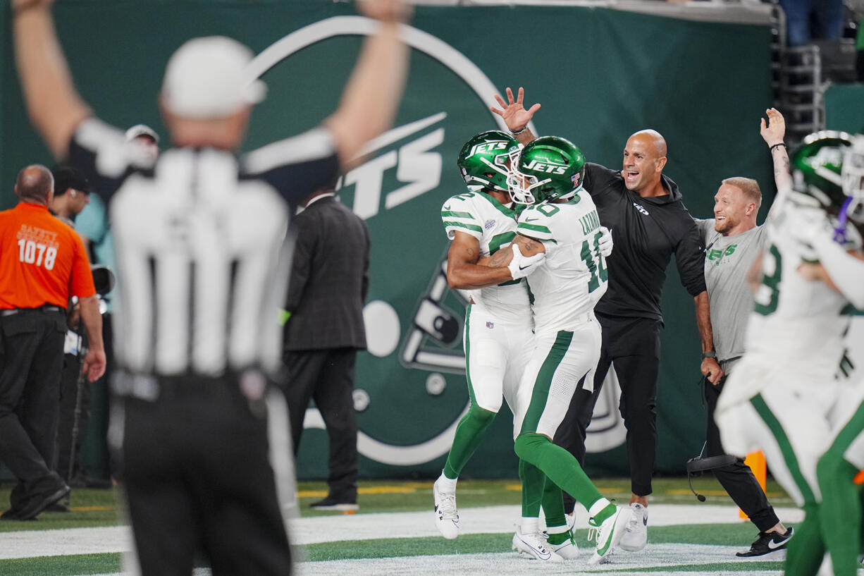 New York Jets wide receiver Xavier Gipson (82) celebrates an overtime touchdown punt return with wide receiver Allen Lazard (10) and head coach Robert Saleh during an NFL football game against the Buffalo Bills on Monday, Sep. 11, 2023, in East Rutherford, N.J.