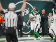 New York Jets wide receiver Xavier Gipson (82) celebrates an overtime touchdown punt return with wide receiver Allen Lazard (10) and head coach Robert Saleh during an NFL football game against the Buffalo Bills on Monday, Sep. 11, 2023, in East Rutherford, N.J.