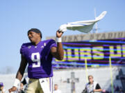 Washington quarterback Michael Penix Jr. waves a towel while celebrating a 56-19 win over Boise State in an NCAA college football game, Saturday, Sept. 2, 2023, in Seattle.