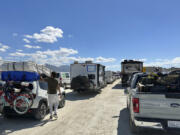 Vehicles line up in a several-hour wait to leave the Burning Man festival in Black Rock Desert, Nev., on Tuesday.