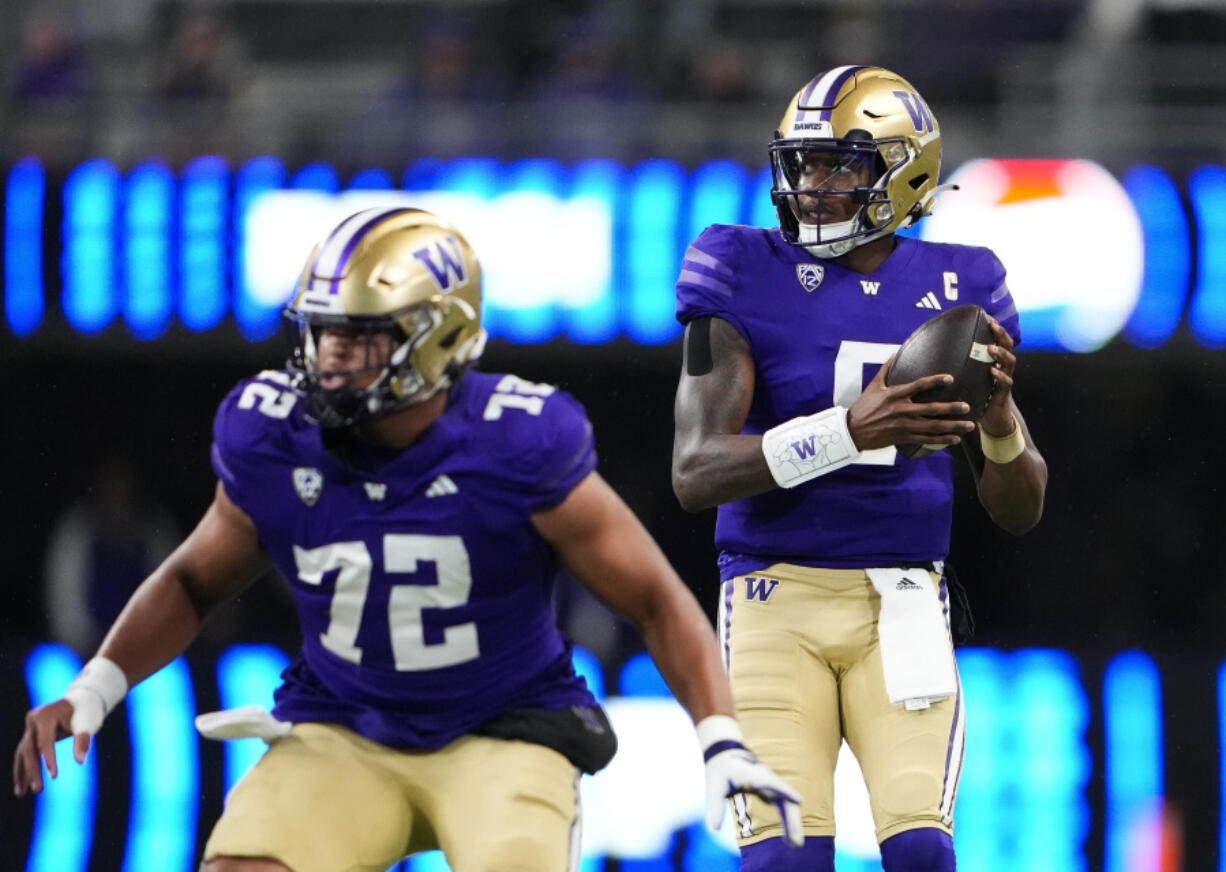 Washington quarterback Michael Penix Jr. (9) looks for a receiver from behind offensive lineman Parker Brailsford (72) during the first half of the team's NCAA college football game against California on Saturday, Sept. 23, 2023, in Seattle.