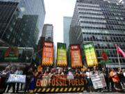 Climate activists block traffic on Park Avenue during a march protesting energy policies and the use of fossil fuels, in New York, Sunday, Sept. 17, 2023.