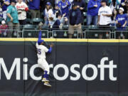 Seattle Mariners right fielder Teoscar Hernandez leaps but is unable to catch the home run ball hit by Los Angeles Dodgers' Jason Heyward during the first inning of a baseball game, Sunday, Sept. 17, 2023, in Seattle.