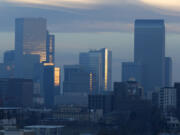 FILE - Pollution obscures the skyline of downtown as the sun rises over Denver, on Feb. 28, 2019. The Environmental Protection Agency is delaying plans to tighten air quality standards for ground-level ozone -- better known as smog -- despite a recommendation by a scientific advisory panel to lower air pollution limits to protect public health.