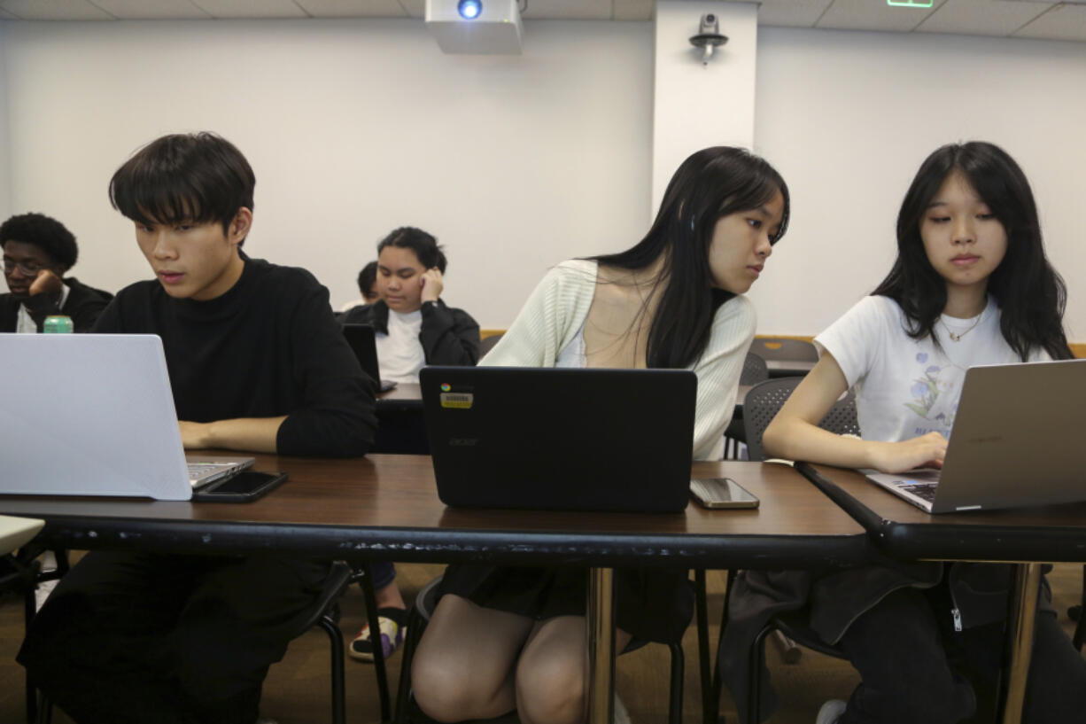 Students, from left, Zhuo Yan Jiang, 18 of Boston Latin School; Shuyi Zheng, 17 of Boston Latin Academy, and Wan Xin Chen, 17 of the John D. O'Bryant School of Mathematics & Science, work during a coding class in the Bridge to Calculus summer program at Northeastern University in Boston on Tuesday, Aug. 1, 2023.