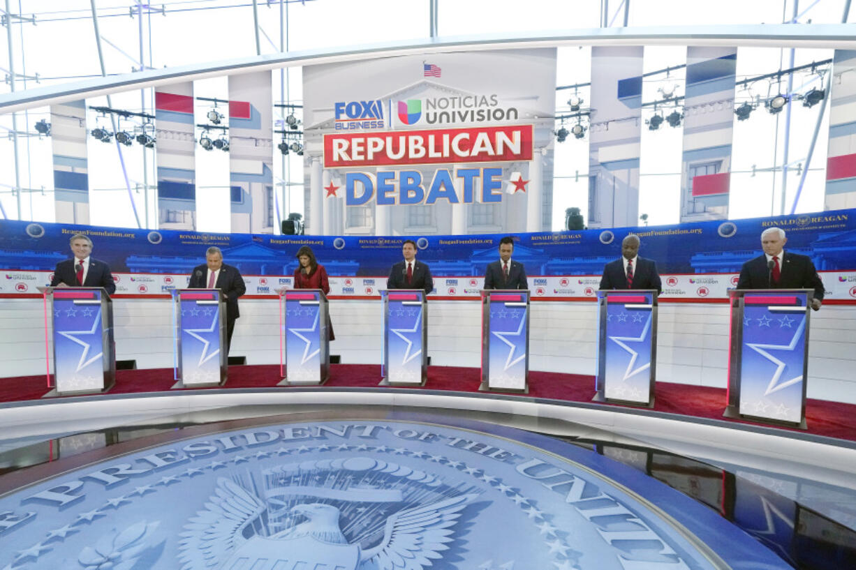 Republican presidential candidates, from left, North Dakota Gov. Doug Burgum, former New Jersey Gov. Chris Christie, former U.N. Ambassador Nikki Haley, Florida Gov. Ron DeSantis, entrepreneur Vivek Ramaswamy, Sen. Tim Scott, R-S.C., and former Vice President Mike Pence, stand at their podiums during a Republican presidential primary debate hosted by FOX Business Network and Univision, Wednesday, Sept. 27, 2023, at the Ronald Reagan Presidential Library in Simi Valley, Calif. (AP Photo/Mark J.