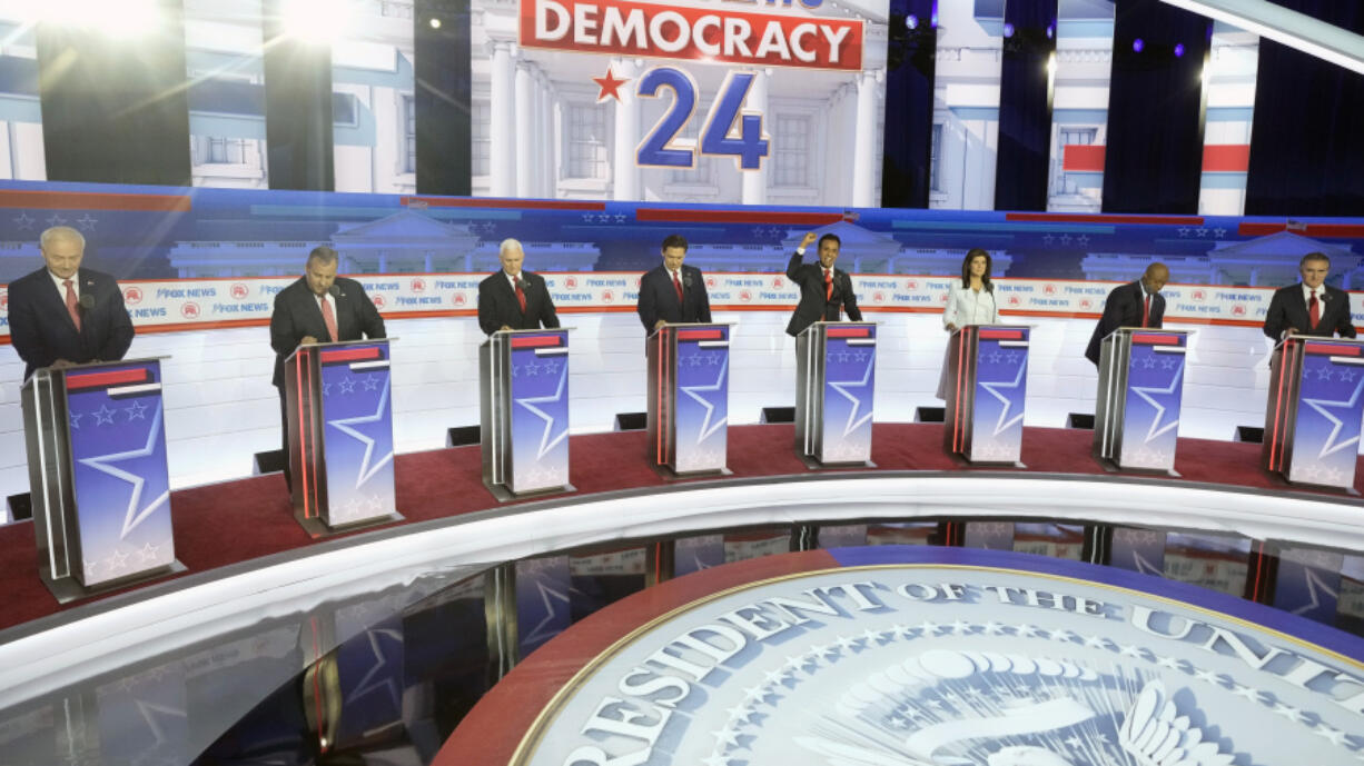 FILE - Republican presidential candidates, from left, former Arkansas Gov. Asa Hutchinson, former New Jersey Gov. Chris Christie, former Vice President Mike Pence, Florida Gov. Ron DeSantis, businessman Vivek Ramaswamy, former U.N. Ambassador Nikki Haley, Sen. Tim Scott, R-S.C., and North Dakota Gov. Doug Burgum stand on stage before a Republican presidential primary debate hosted by FOX News Channel, Aug. 23, 2023, in Milwaukee.