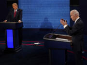 FILE - Democratic presidential candidate former Vice President Joe Biden answers a question as President Donald Trump listens during the second and final presidential debate Oct. 22, 2020, at Belmont University in Nashville, Tenn. The two front-runners for their party's nominations, former President Donald Trump and President Joe Biden, are barely campaigning in crucial early voting states as the primary season enters the fall rush.