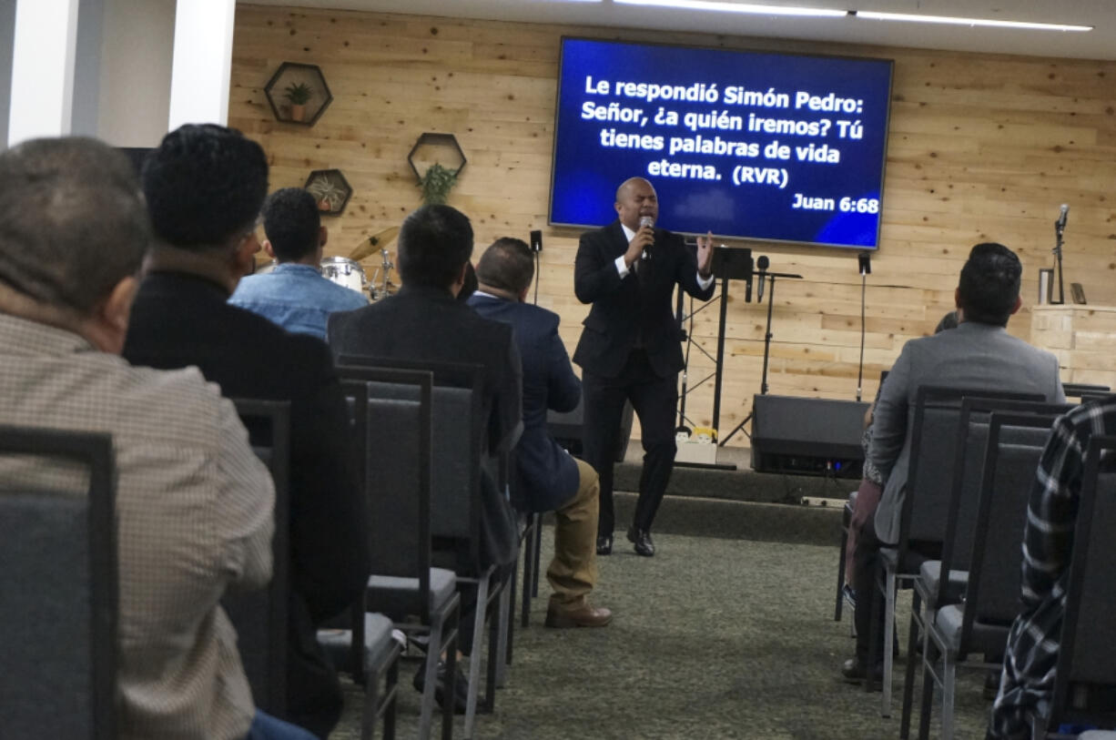 The Rev. Gustavo Castillo preaches to his congregation at the Iglesia Pentecostal Unida Latinoamericana in Columbia Heights, Minn., on Sunday, Sept. 24, 2023. The federal government recently moved thousands of green card applications for vulnerable minors from Central America in the queue for religious workers, leading to long delays and thus putting ministers on temporary work visas like Castillo at risk of losing the ability to stay in the United States.