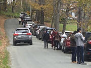 People and cars line a narrow road outside a private property in an undated photo, in Pomfret, Vt., that has become a destination for fall foliage viewers, clogging the rural road. The town is closing the road to leaf peepers through mid-October 2023 because it says the increased traffic has caused significant safety, environmental, aesthetic and quality of life issues.