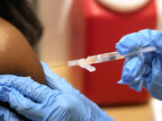 A pharmacist administers a Moderna Spikevax COVID-19 vaccine at a drug store, Wednesday, Sept. 20, 2023, in Cypress, Texas. Fall 2023 vaccination season is in full swing, with health officials in the U.S. urging both an updated COVID-19 shot and flu vaccine for most everyone. New this year are vaccines for older adults and women in late pregnancy to guard against another virus named RSV.