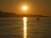 FILE - The sun sets on the Great Salt Lake on June 15, 2023, near Magna, Utah. A coalition of environmental organizations sued the state of Utah on Wednesday, Sept. 6, 2023, based on accusations that it is not doing enough make sure enough water gets to the shrinking Great Salt Lake.