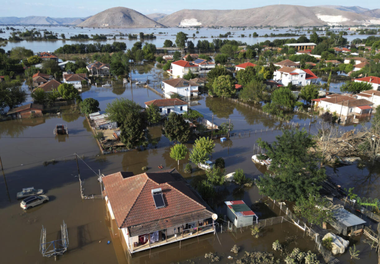 Floodwaters and mud cover the town of Palamas, after the country's rainstorm record, in Karditsa, Thessaly region, central Greece, Friday, Sept. 8, 2023. Rescue crews in helicopters and boats are plucking people from houses in central Greece inundated by tons of water and mud after severe rainstorms caused widespread flooding.