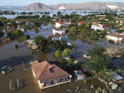 Floodwaters and mud cover the town of Palamas, after the country's rainstorm record, in Karditsa, Thessaly region, central Greece, Friday, Sept. 8, 2023. Rescue crews in helicopters and boats are plucking people from houses in central Greece inundated by tons of water and mud after severe rainstorms caused widespread flooding.