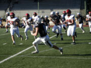 Heritage’s Luke Melvin (8) heads downfield after making a catch during the Timberwolves’ game against East Valley of Yakima at McKenzie Stadium on Friday, Sept. 15, 2023.