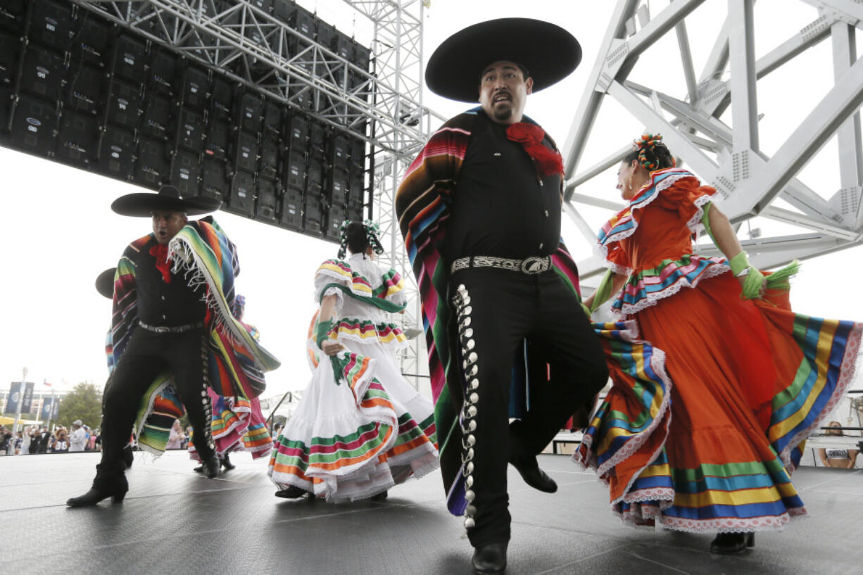 FILE - Members of a Ballet Folklorico perform outside AT&T stadium as part of the Hispanic Heritage Month celebration before an NFL football game between the New Orleans Saints and Dallas Cowboys, Sept. 28, 2014, in Arlington, Texas. Hispanic history and culture take center stage across the U.S. for National Hispanic Heritage Month. The celebration recognizes contributions made by Hispanic Americans, the fastest-growing racial or ethnic minority according to the Census, and with a U.S. population of over 63 million people, there will be a plethora of Hispanic Heritage Month celebrations all over the country starting Friday, Sept. 15, 2023.