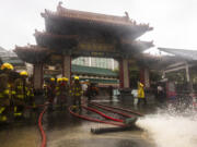 Fire-fighters drain out water following heavy rainstorms in Hong Kong, Friday, Sept. 8, 2023. Rain pouring onto Hong Kong and southern China overnight flooded city streets and some subway stations, halting transportation and forcing schools to close Friday.