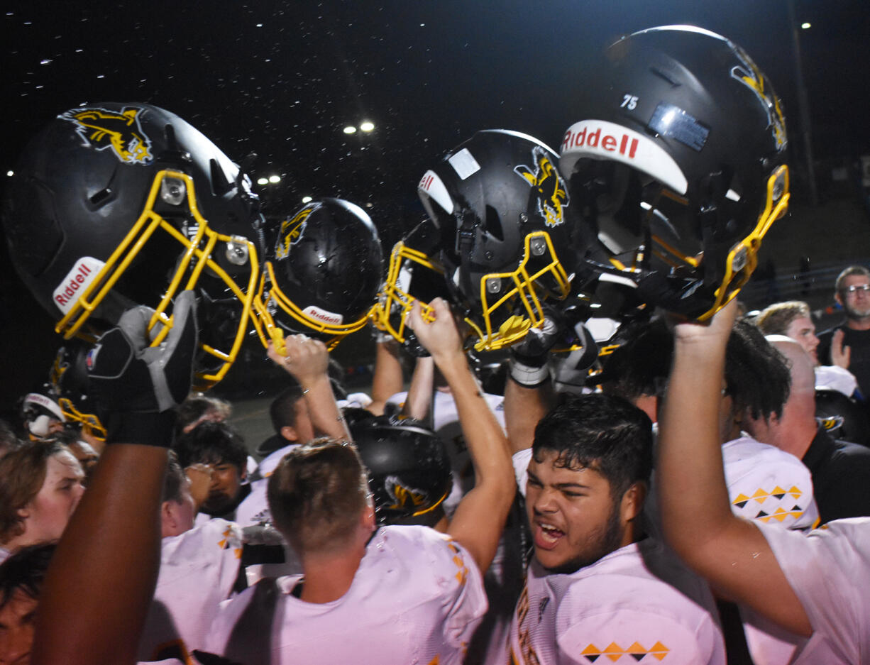 Hudson's Bay players celebrate after the Eagles' 28-24 win over Ridgefield at Ridgefield High School on Friday, Sept. 22, 2023.