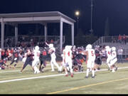 Yelm's Anthony Kiamco (25) blocks Trenton Swanson's potential game-winning field goal in the closing seconds of Friday's game. Yelm beat Camas, 8-7.