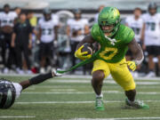 Hawaii defensive back Caleb Brown slows down Oregon running back Bucky Irving (0) during the first half of an NCAA college football game Saturday, Sept. 16, 2023, in Eugene, Ore.