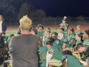 Evergreen coach Christian Swain, left, talks to his team after the Plainsmen fell to Glacier Peak, 21-0, on Friday, Sept. 22, 2023, at McKenzie Stadium.