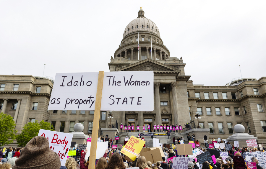 FILE - An attendee at Planned Parenthood's Bans Off Our Bodies rally for abortion rights holds a sign reading outside of the Idaho Statehouse in downtown Boise, Idaho, on May 14, 2022. Women in Idaho, Tennessee and Oklahoma are challenging strict abortion laws that went into effect after the Supreme Court overturned Roe v. Wade last year. Two state lawsuits were filed on Tuesday, Sept. 12, 2023, in Idaho and Tennessee after women were denied care while facing harrowing pregnancy complications. Meanwhile, a federal complaint was filed in Oklahoma after a woman couldn't receive an abortion despite having a dangerous and nonviable pregnancy. (Sarah A.