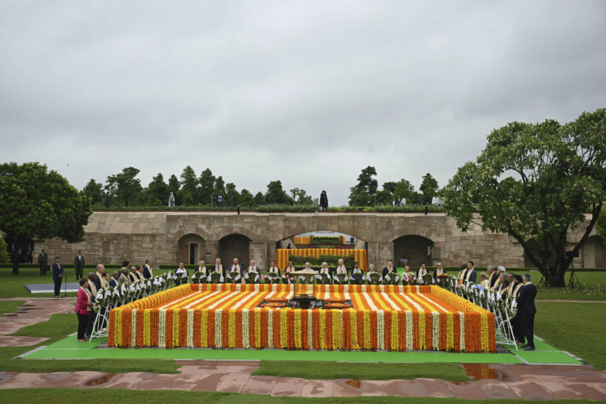 U.S. President Joe Biden, center, with other G20 leaders pay their respects at the Rajghat, a Mahatma Gandhi memorial, in New Delhi, India, Sunday, Sept. 10, 2023.