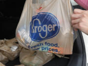 FILE - A customer removes her purchases at a Kroger grocery store in Flowood, Miss., Wednesday, June 26, 2019.   Kroger and Albertsons are selling more than 400 stores and other assets to C&S Wholesale Grocers in an approximately $1.9 billion deal as part of their efforts to complete their merger, Friday, Sept. 8, 2023. (AP Photo/Rogelio V.