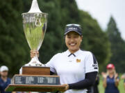 Chanettee Wannasaen, of Thailand, holds the trophy after winning the LPGA Portland Classic golf tournament in Portland, Ore., Sunday, Sept. 3, 2023.