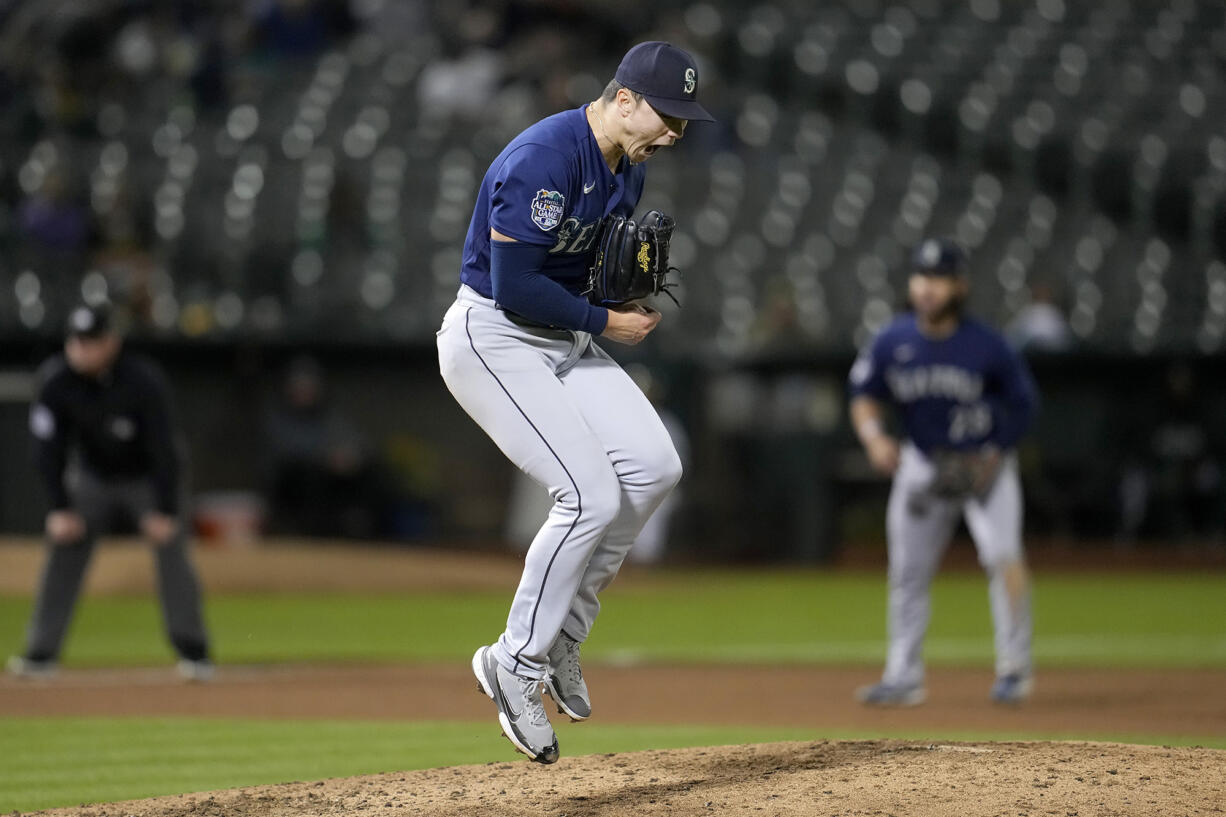 Seattle Mariners pitcher Bryan Woo celebrates after striking out Oakland Athletics' Nick Allen during the fourth inning of a baseball game in Oakland, Calif., Monday, Sept. 18, 2023.