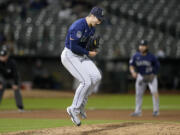 Seattle Mariners pitcher Bryan Woo celebrates after striking out Oakland Athletics' Nick Allen during the fourth inning of a baseball game in Oakland, Calif., Monday, Sept. 18, 2023.