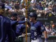 Seattle Mariners' Dominic Canzone (8) celebrates after hitting a two-run home run against the Oakland Athletics during the second inning of a baseball game in Oakland, Calif., Wednesday, Sept. 20, 2023.