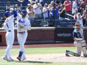 New York Mets' Pete Alonso (20) Jeff McNeil (1) celebrate after hitting a home run against the Seattle Mariners during the third inning of a baseball game, Sunday, Sept. 3, 2023 in New York. (AP Photo/Noah K.